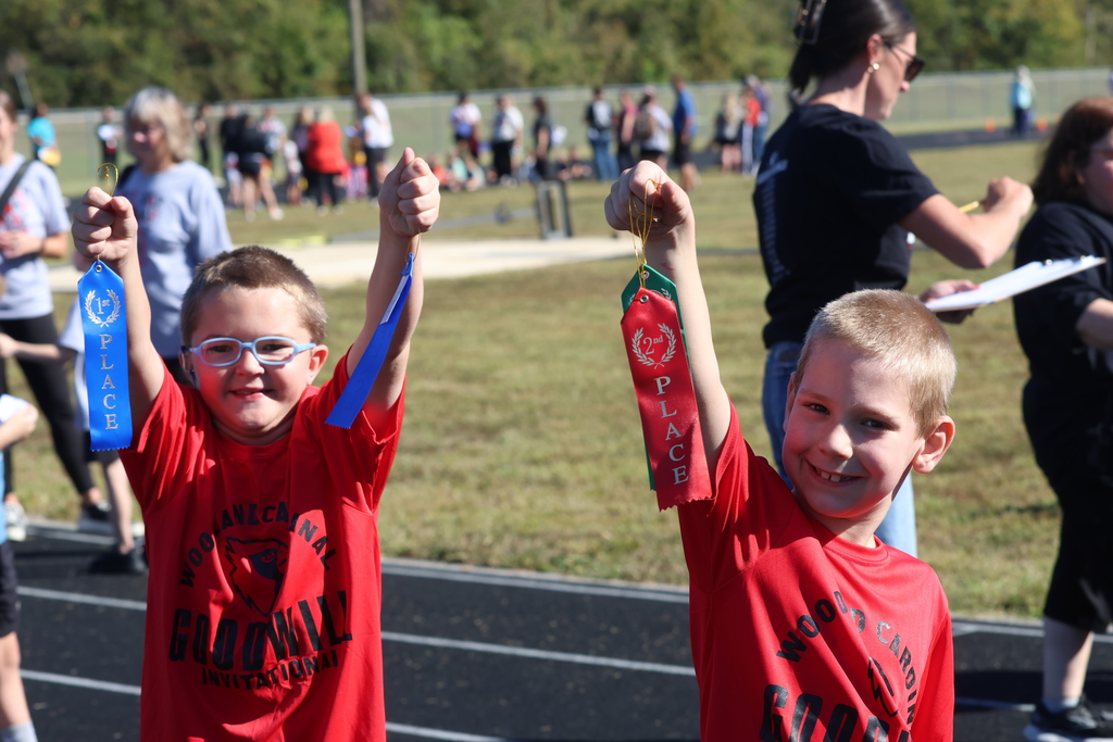 Two Elementary Students  Showing Their Ribbons