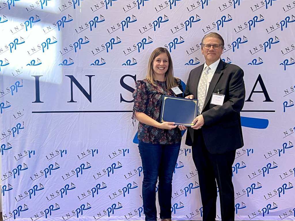 Dr. Machak and Brooke Hagstrom pose for a photo with award
