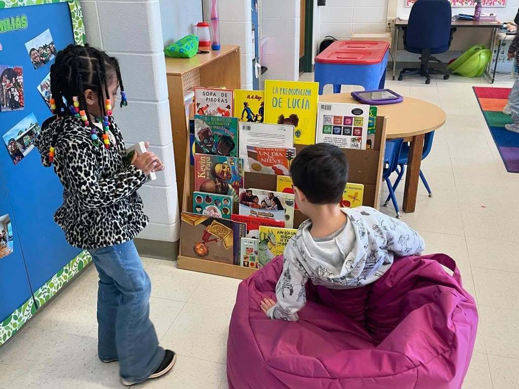 Students picking out books to read in class