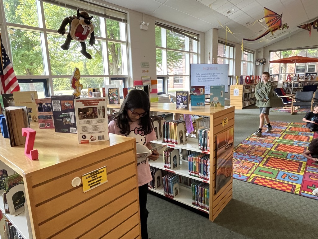 Chromebook care tips and checking out books at the Woodland Intermediate LRC