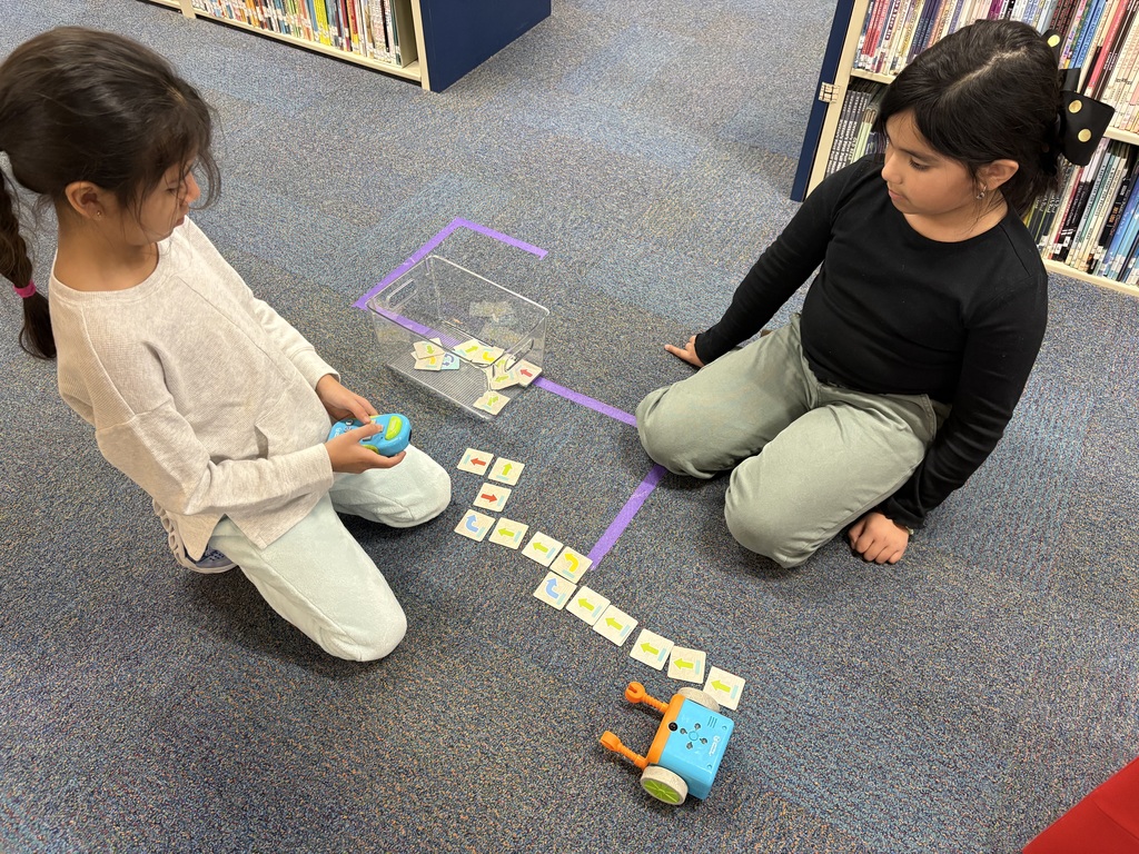 Second graders coding with Botely robots.