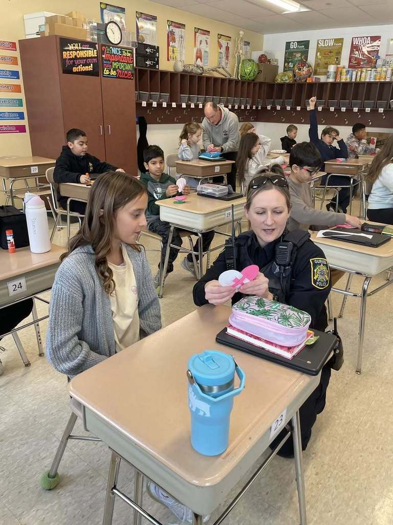 Det. Hansen working with students during health class to create Valentines for members of our community