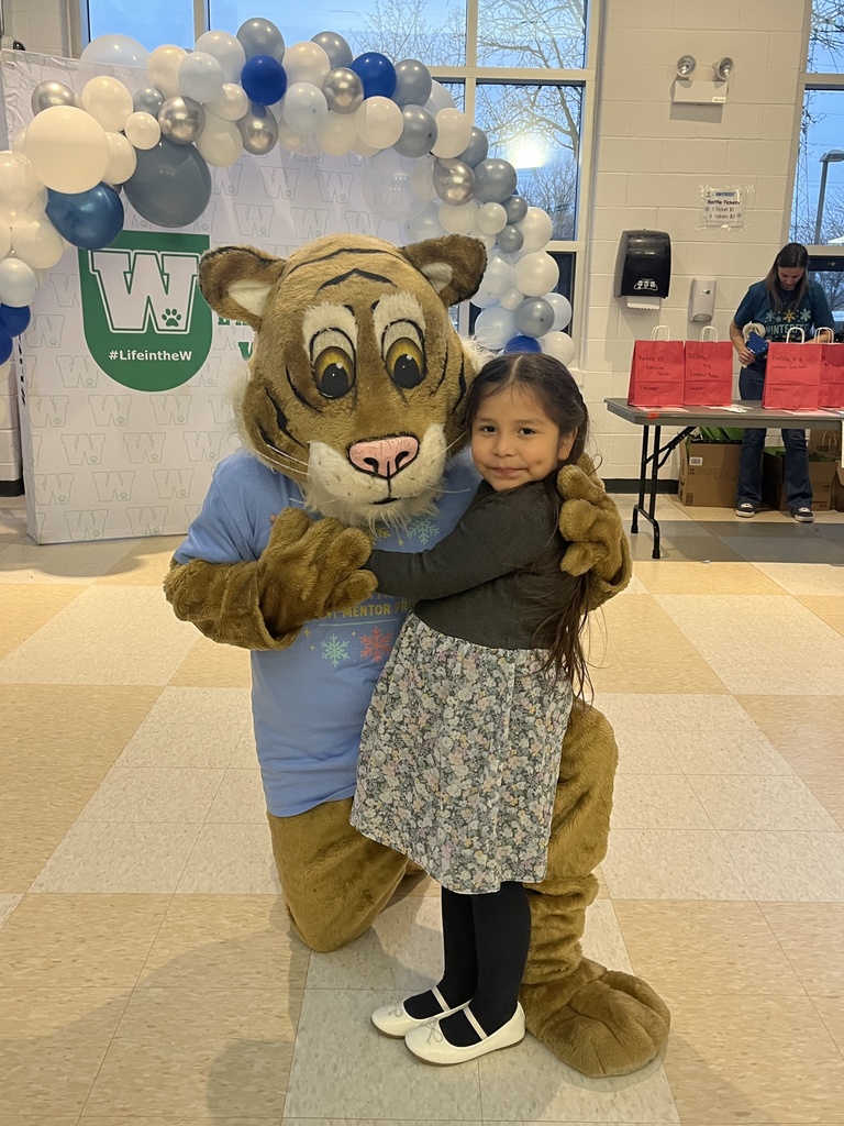 Girl poses with mascot  at WinterFest, Feb. 2026