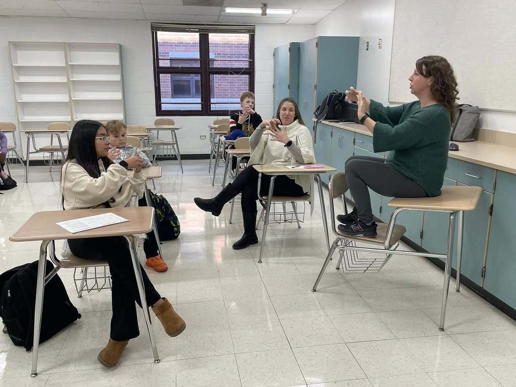 Teacher showing students new signs