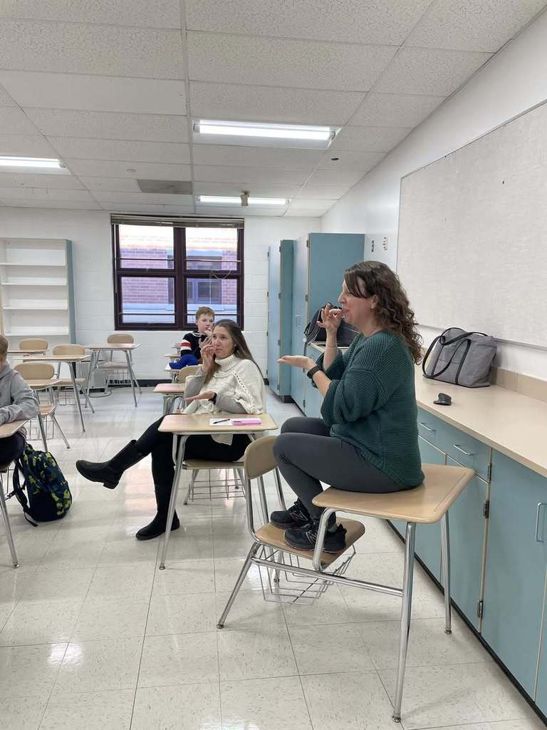 Teacher showing students new signs