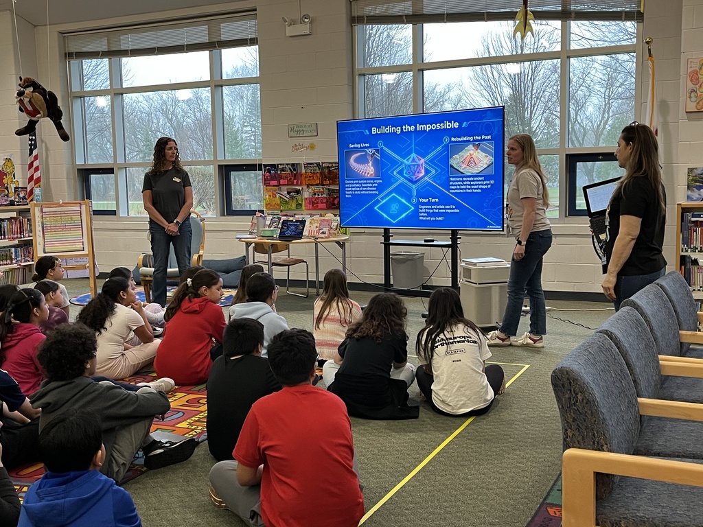 students learn about 3D printing during a presentation in the school library