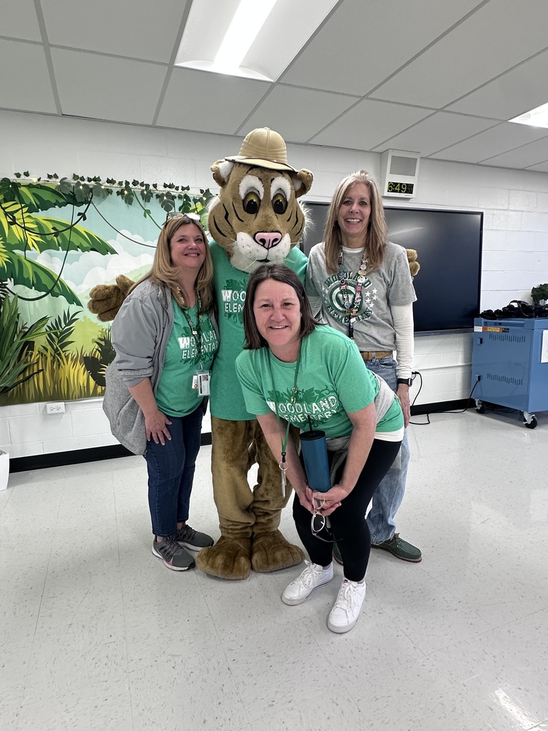 three teachers pose with Wiley the Wildcat at Elementary Family Fun & Games Night April 2026