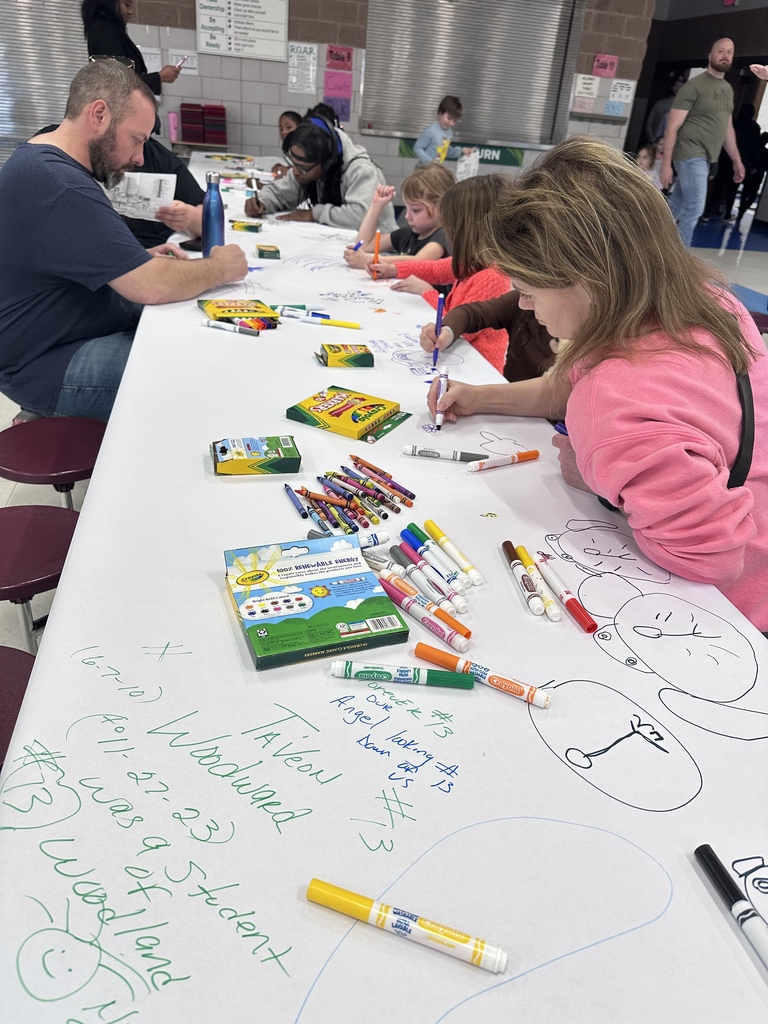 family members make a banner at Elementary Family Fun & Games Night April 2026