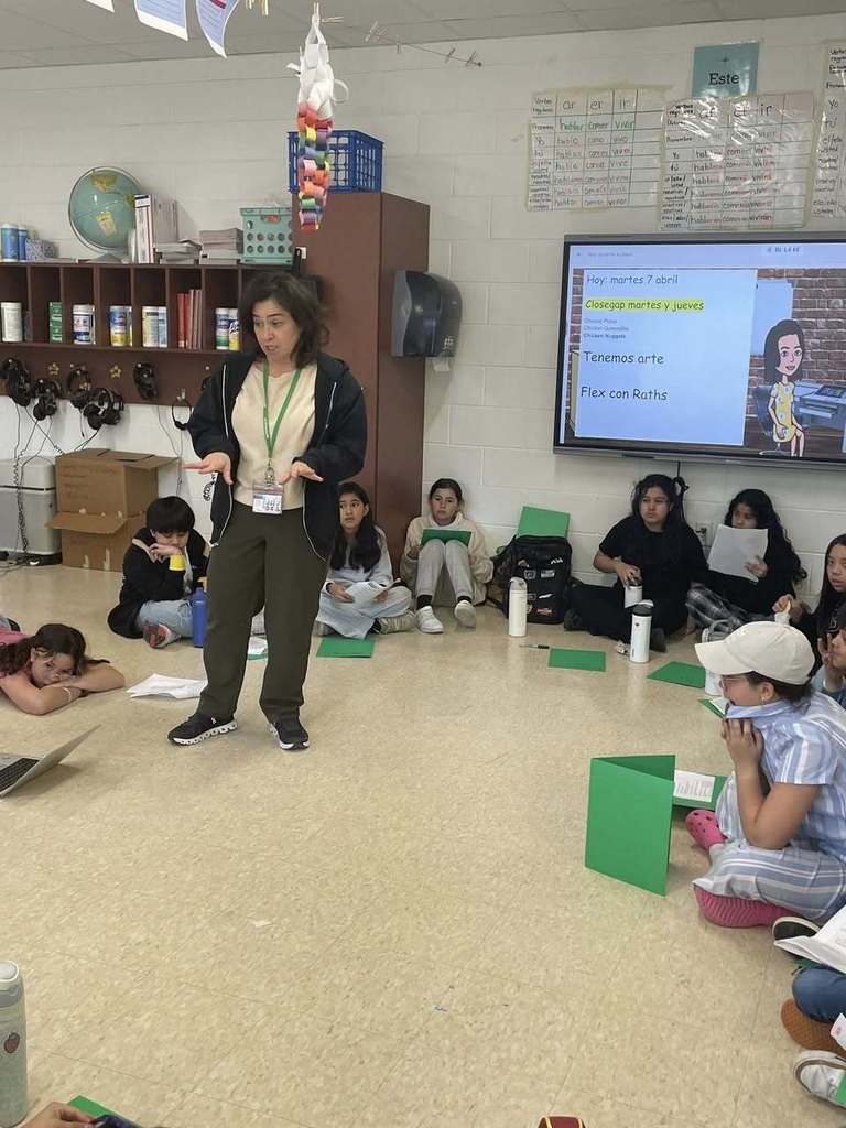 Ms. Raths talk with students in spanish musical club 