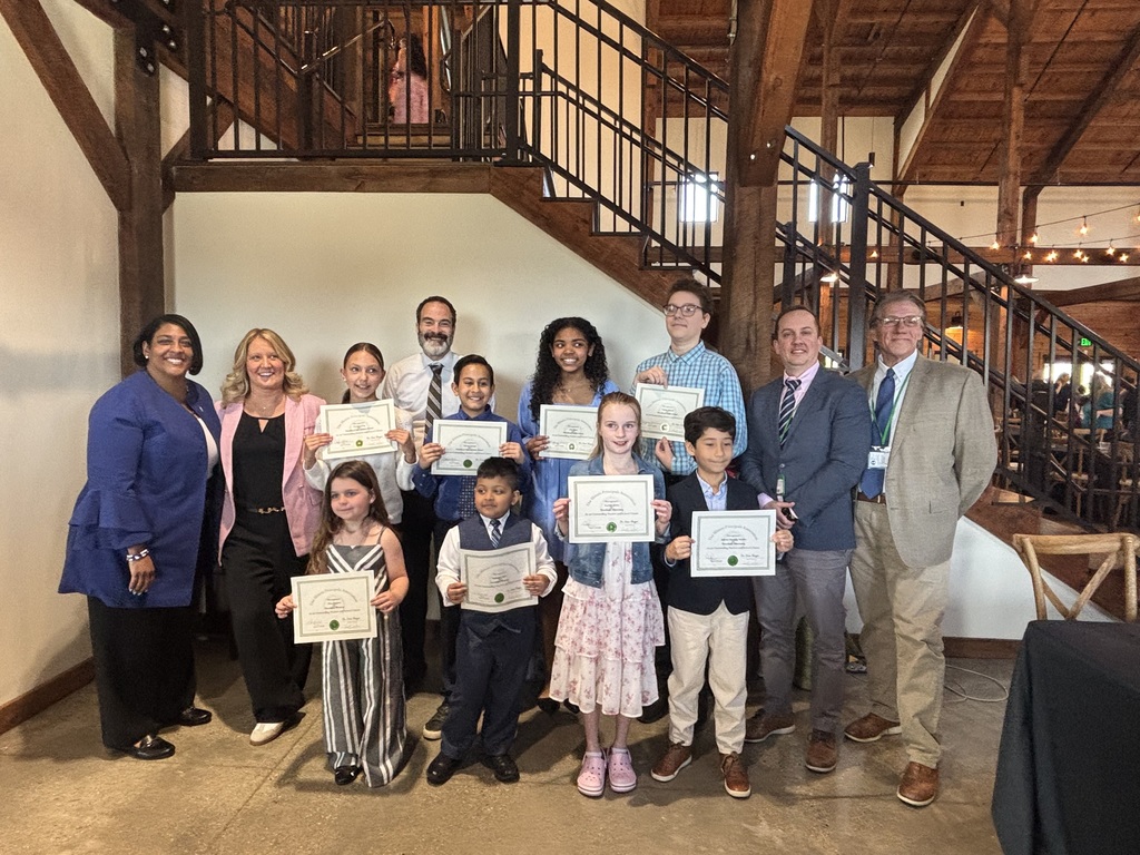 Full group of eight IPA Student Award Winners, four school principals, and the Superintendent pose for a gorup photo April 2026