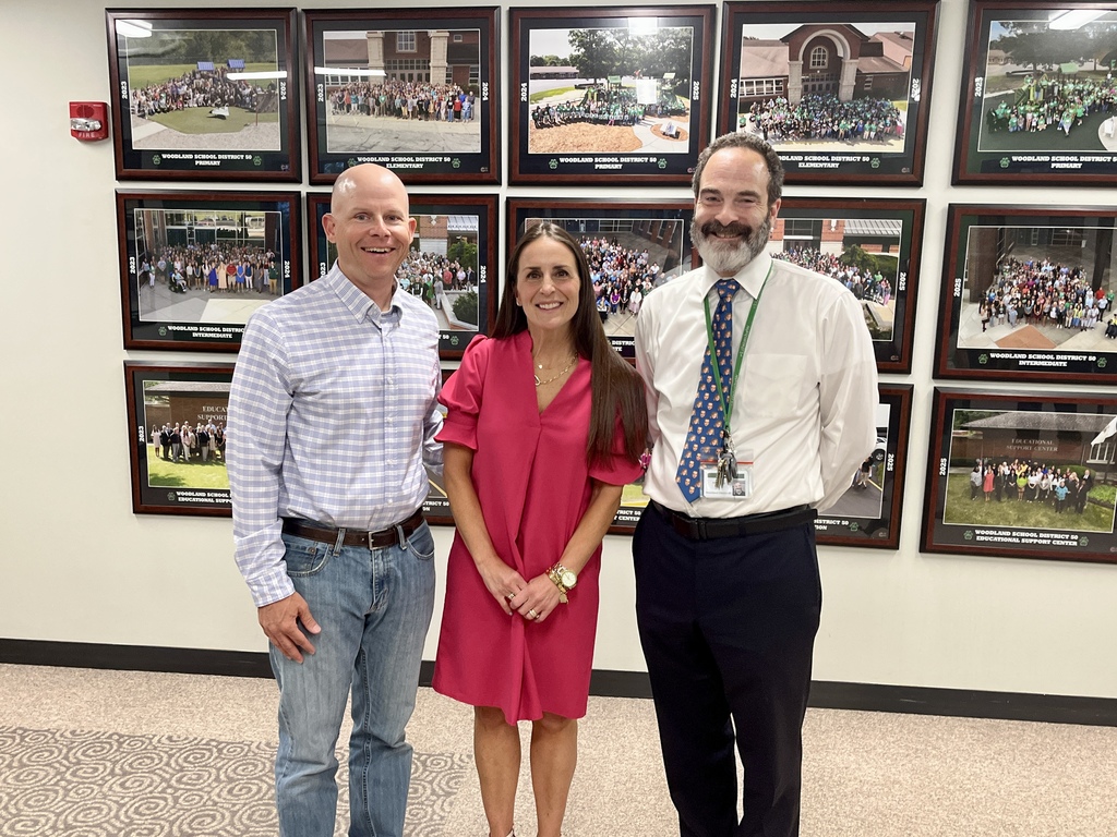Three adults pose for photo  at the Board of Education Meeting April 2026