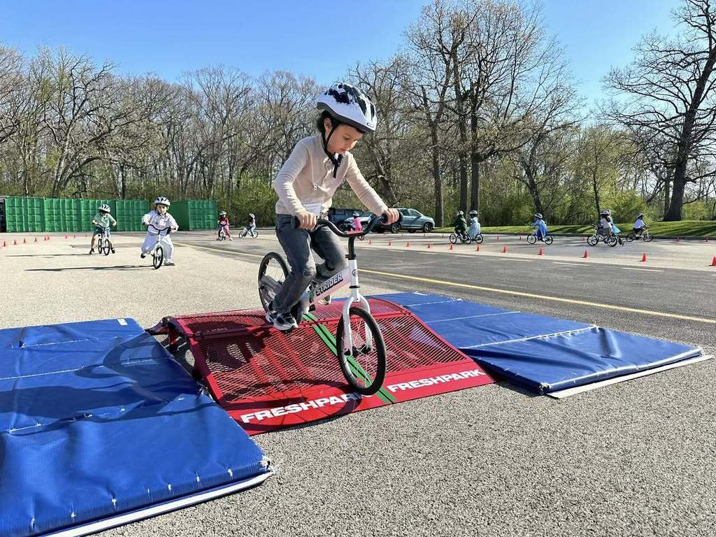 Primary Student on a Bike going over a little ramp 