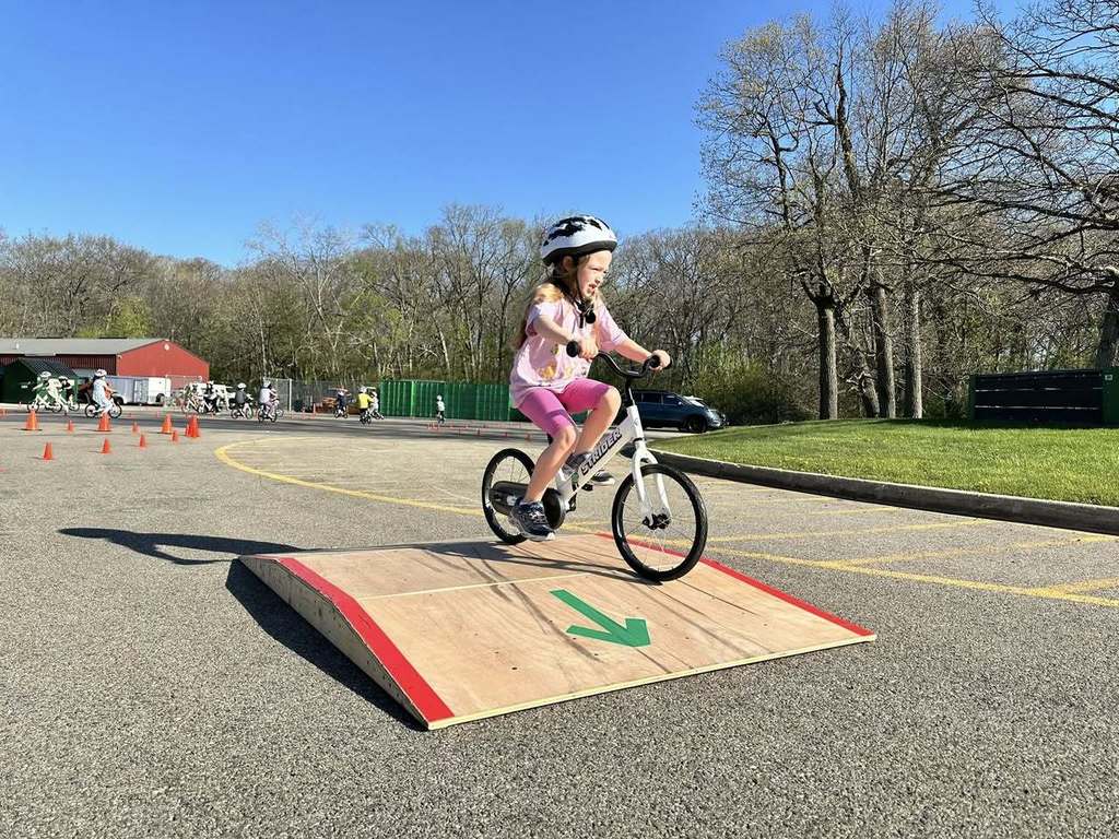 Primary Student on a Bike going over a little ramp 
