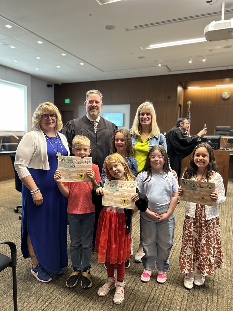Five student artists pose with a Lake County Judge and two art teachers for Law Day May 2026