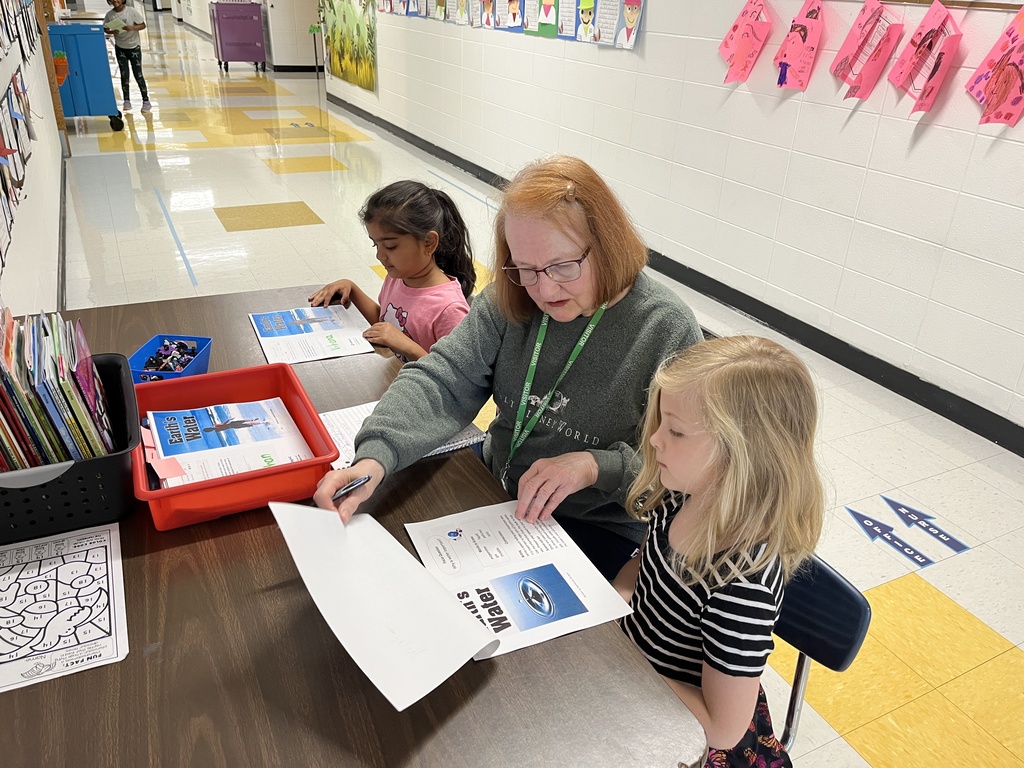 Senior Reader and Community Volunteering reading with two students