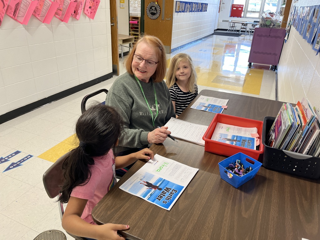 Senior Reader and Community Volunteering reading with two students