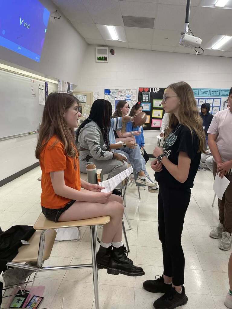 Students giving presentations to their classmates on famous figures in history