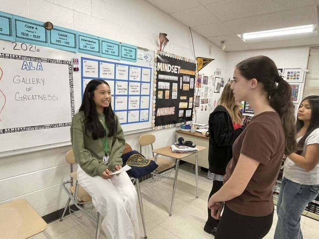 Students giving presentations to their classmates on famous figures in history