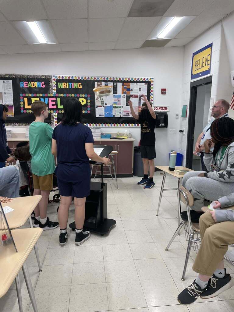 Students giving presentations to their classmates on famous figures in history