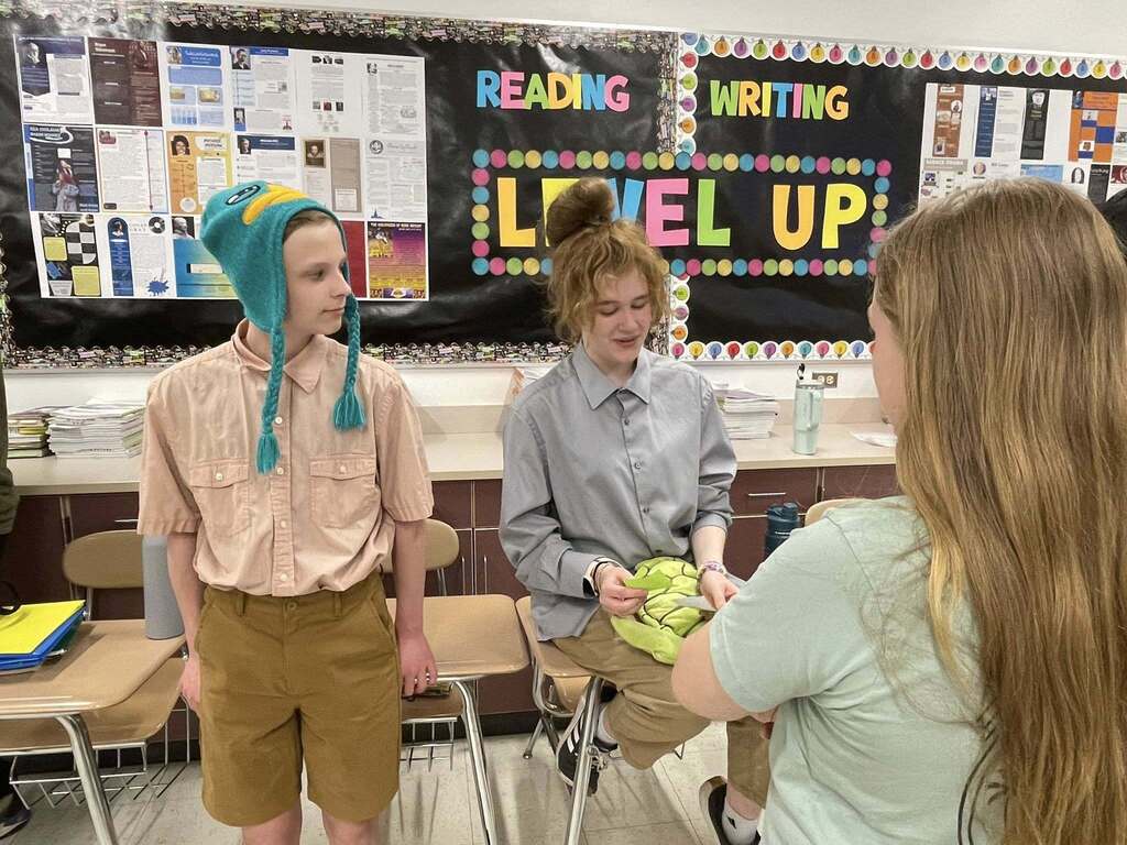 Students giving presentations to their classmates on famous figures in history