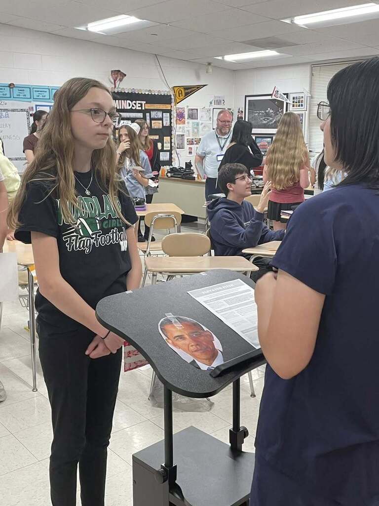 Students giving presentations to their classmates on famous figures in history