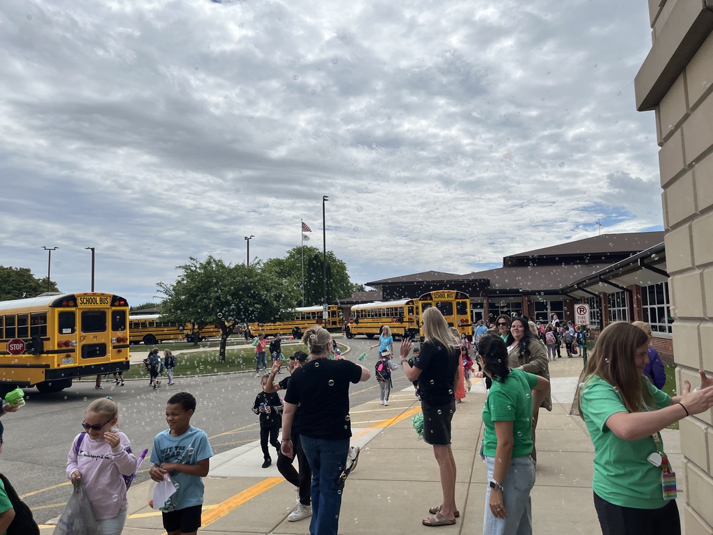 Last day of school at Woodland Elementary. The staff is outside to wave goodbye to the buses!