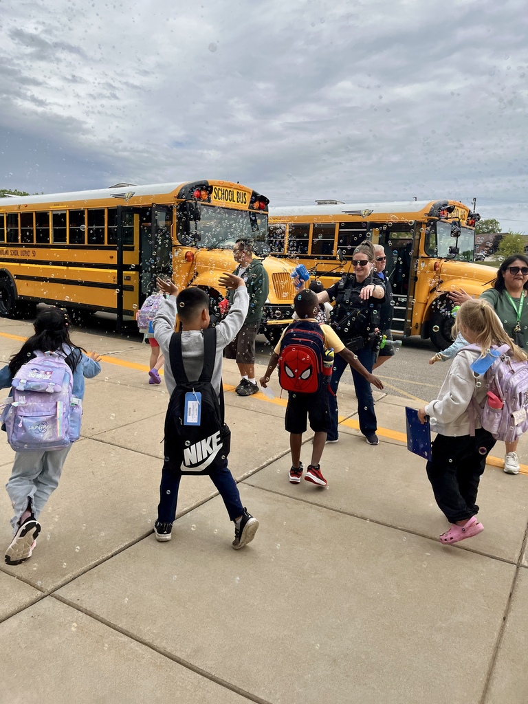 Last day of school at Woodland Elementary. The staff is outside to wave goodbye to the buses!