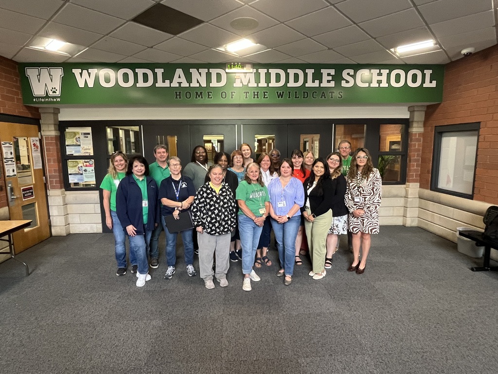 District Office Staff - group photo at the entrance to Woodland Middle School
