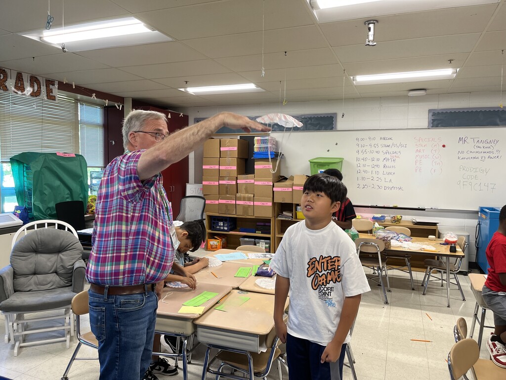 teacher and student test the parachute made by student