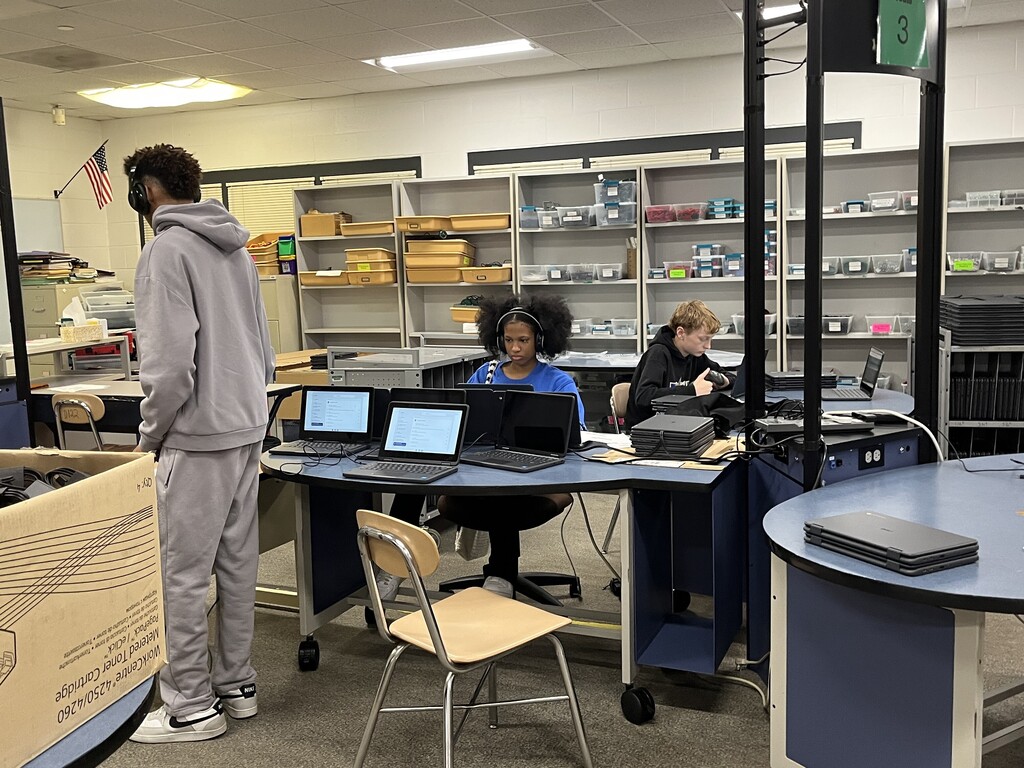Three volunteers help out in the Tech Department during summer break