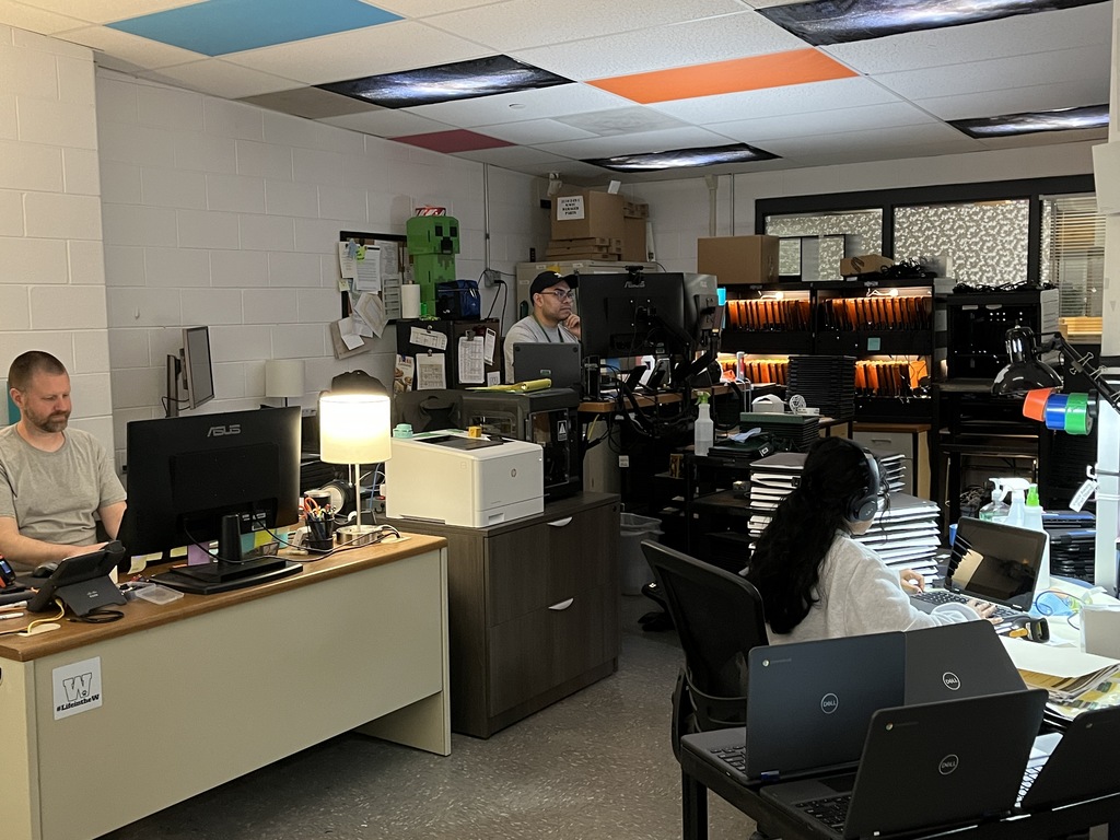 A volunteer helps out in the Tech Department during summer break