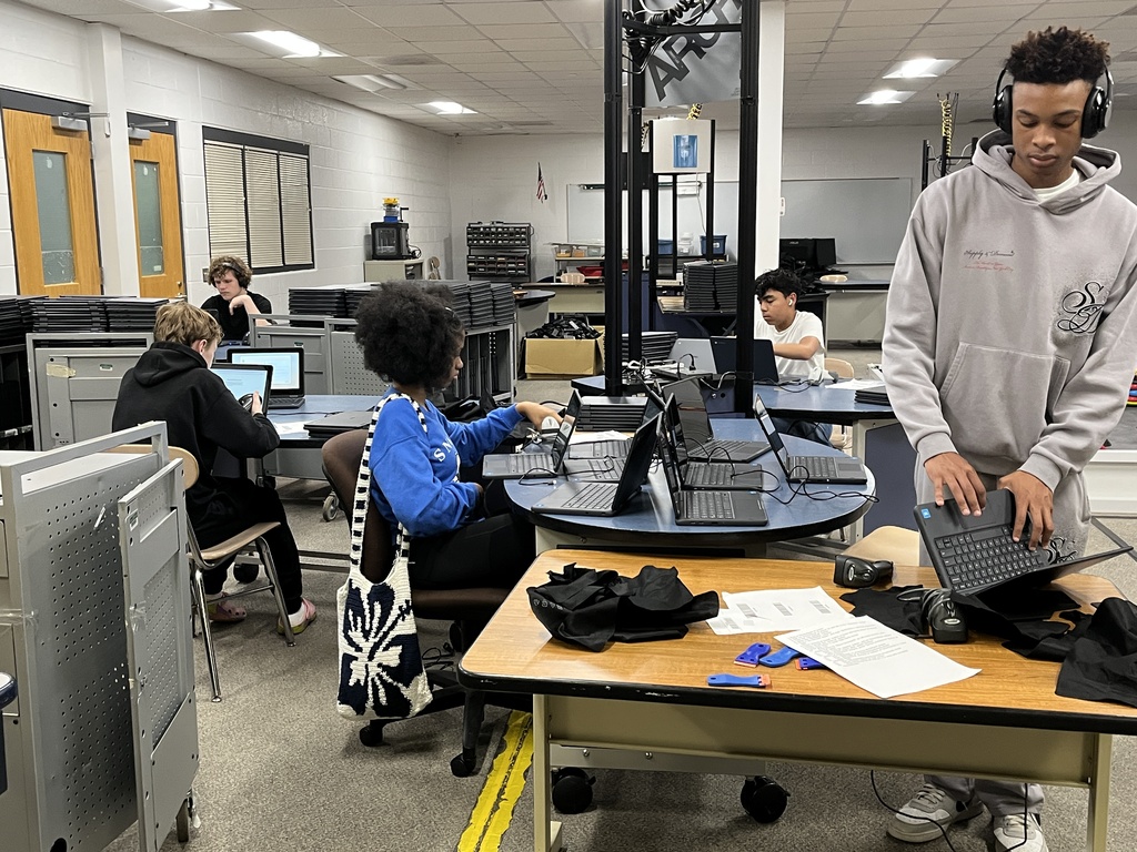 A group of volunteers help out in the Tech Department during summer break