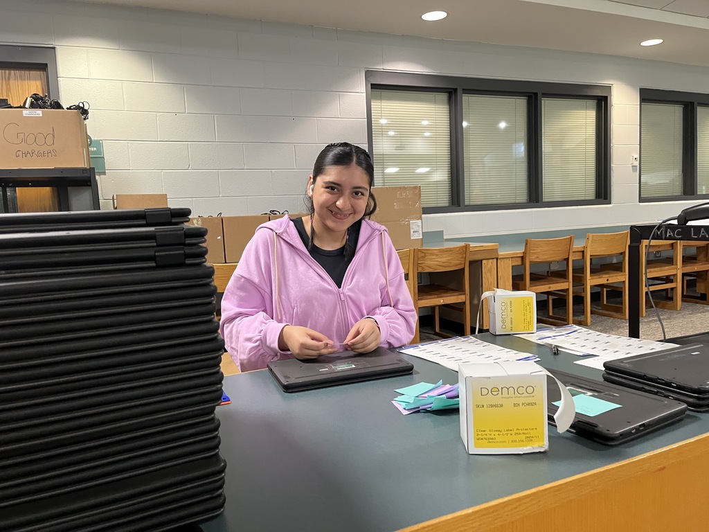 A volunteer helps out in the Tech Department during summer break