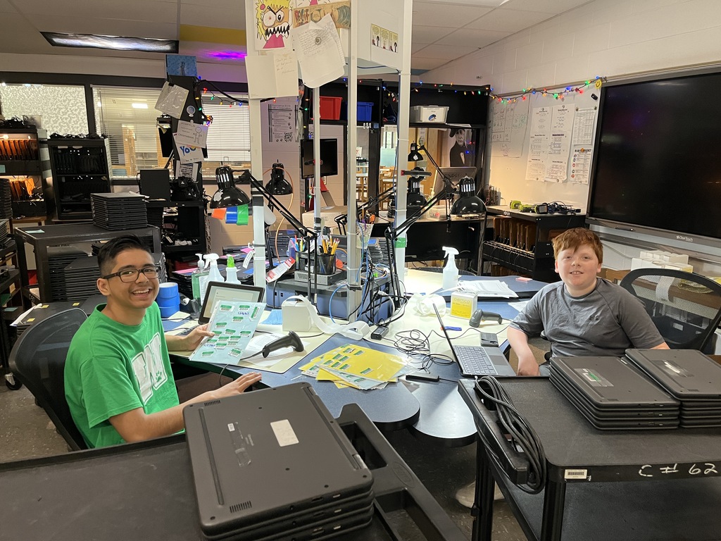 Two volunteers help out in the Tech Department during summer break
