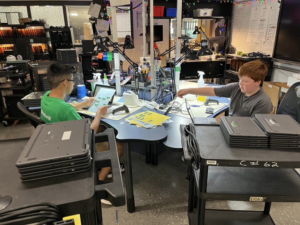Two volunteers help out in the Tech Department during summer break