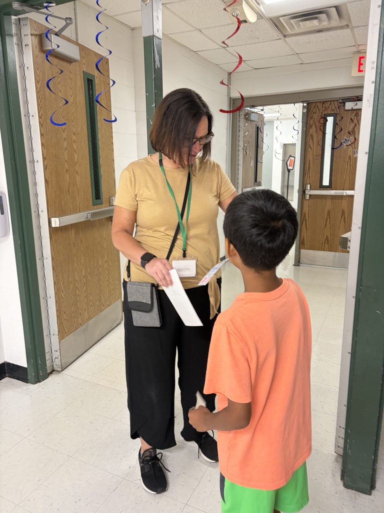Student shares an inspirational bookmark that he made with an adult