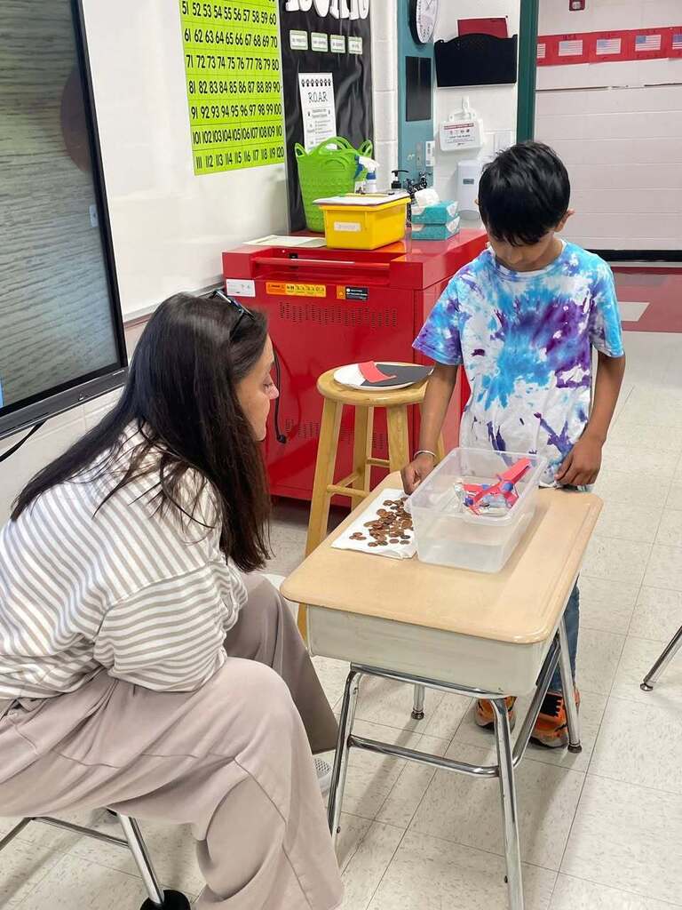Ms Higgins class STEM activity of making boats out of tin foil. Students testing their boats in a tub of water 
