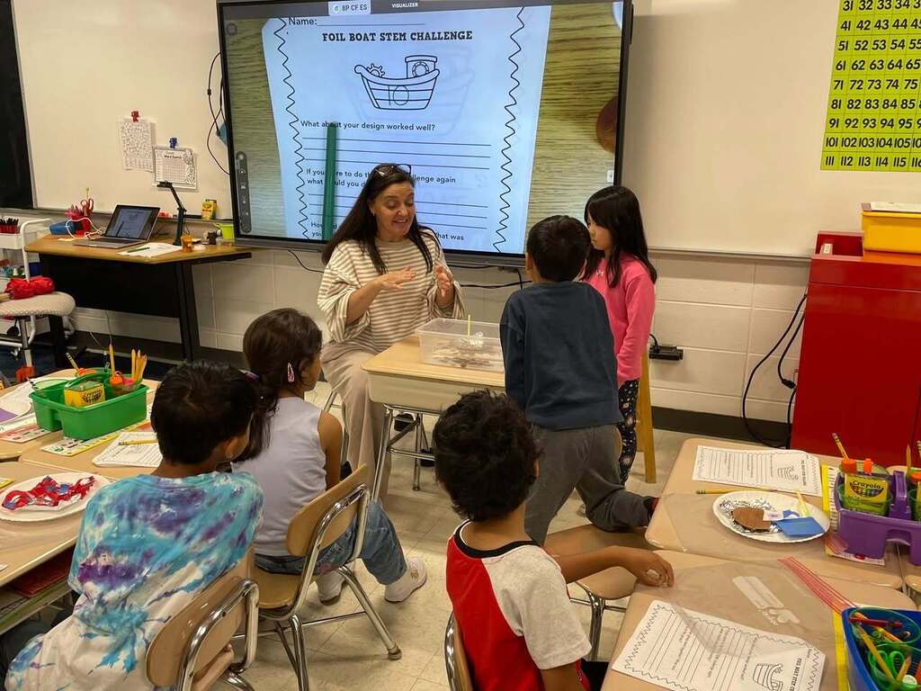 Ms Higgins class STEM activity of making boats out of tin foil. Students testing their boats in a tub of water 