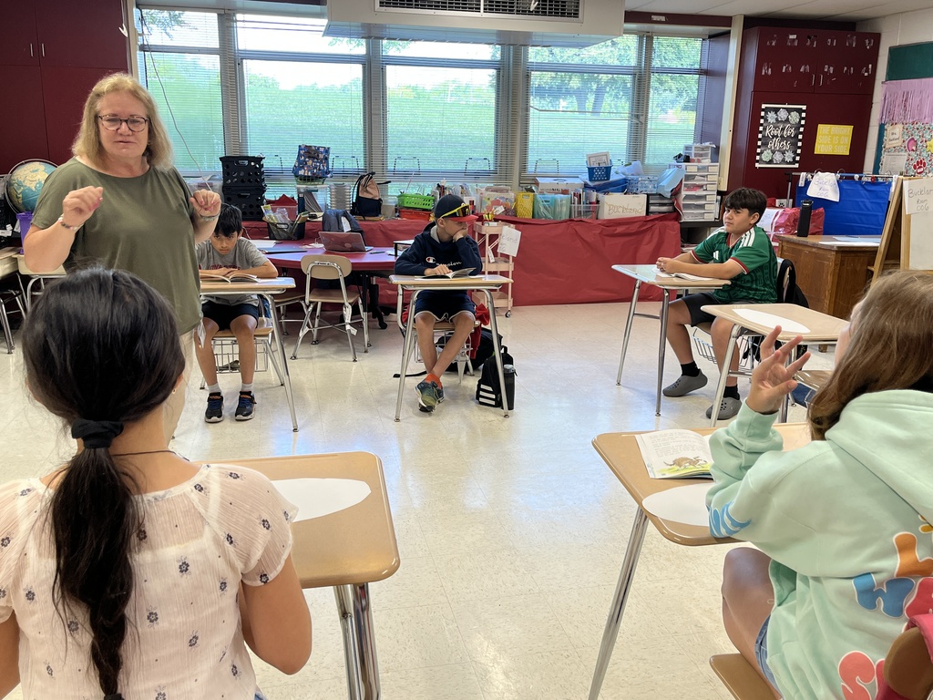 Students engage in a group reading discussion at Summer School