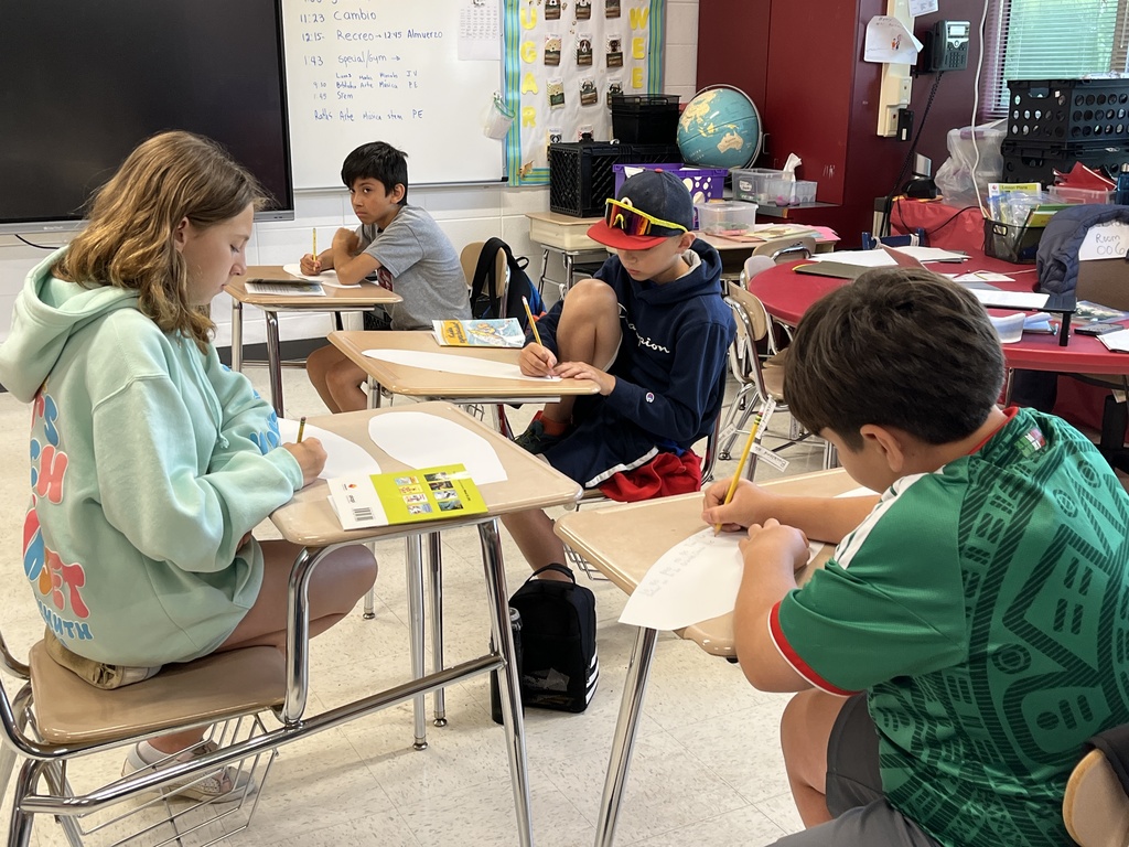 Students engage in a group reading discussion at Summer School
