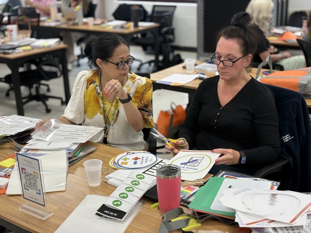 July 2026 Summer Professional Development - staff members interacting in a conference room