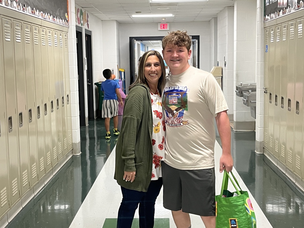 Student poses with former teacher at Sneak Peek, Aug. 2026