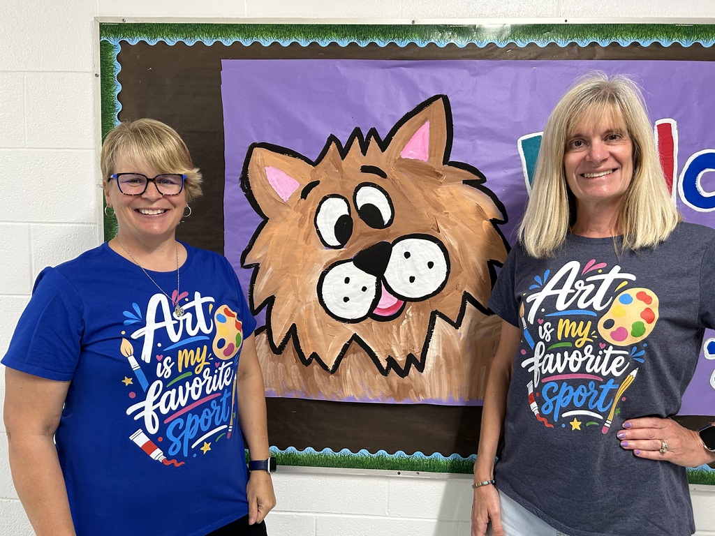 Two Elementary Art Teachers wearing shirts that say "Art is my favorite sport"