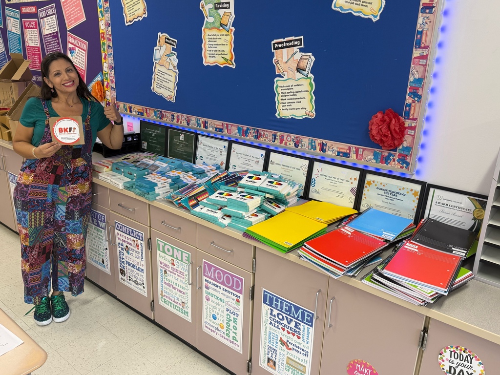 Teacher poses with new school supplies for her class