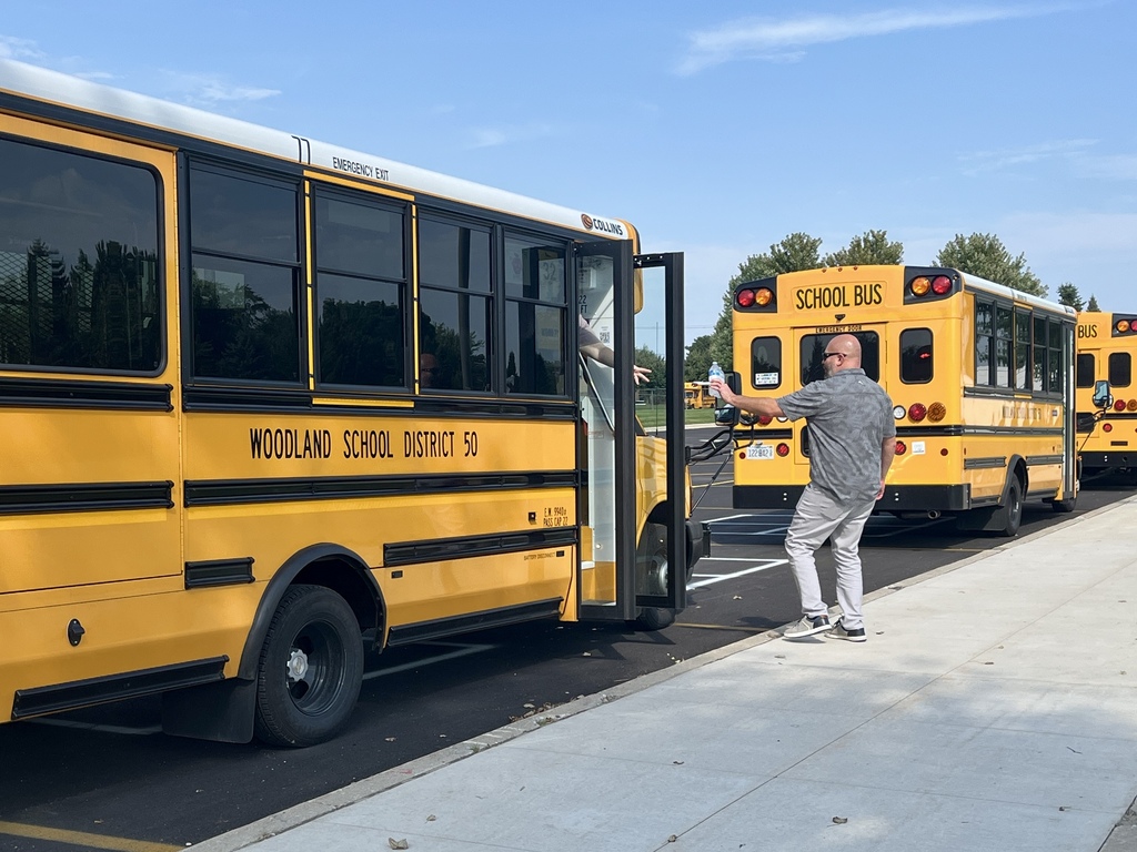 Passing out cold water to bus drivers on a hot day