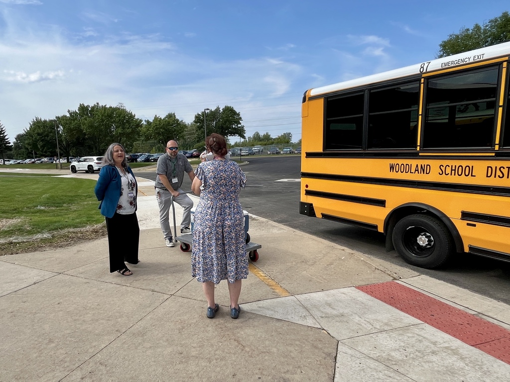Passing out cold water to bus drivers on a hot day