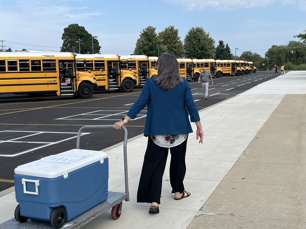 Passing out cold water to bus drivers on a hot day