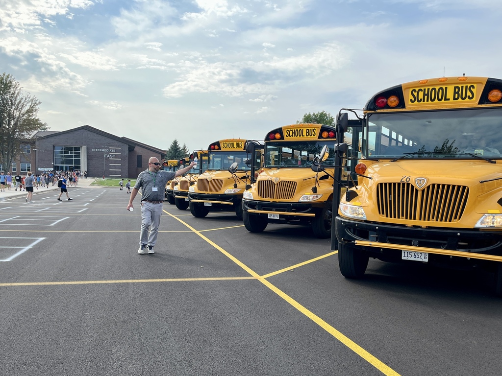 Passing out cold water to bus drivers on a hot day