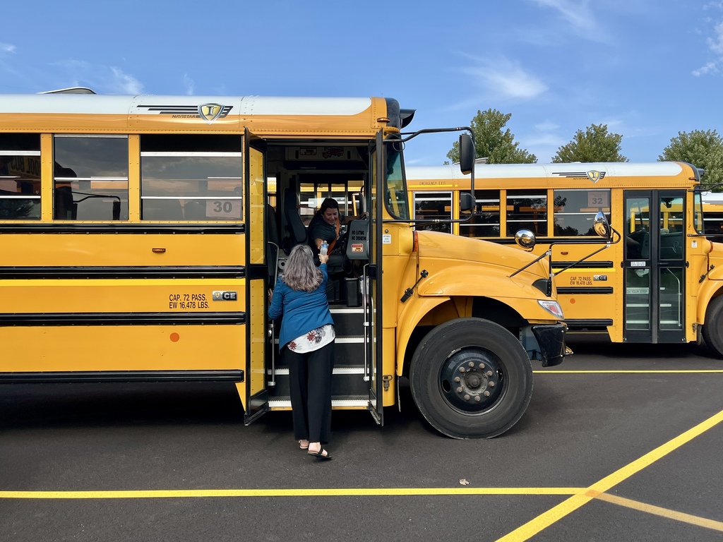 Passing out cold water to bus drivers on a hot day