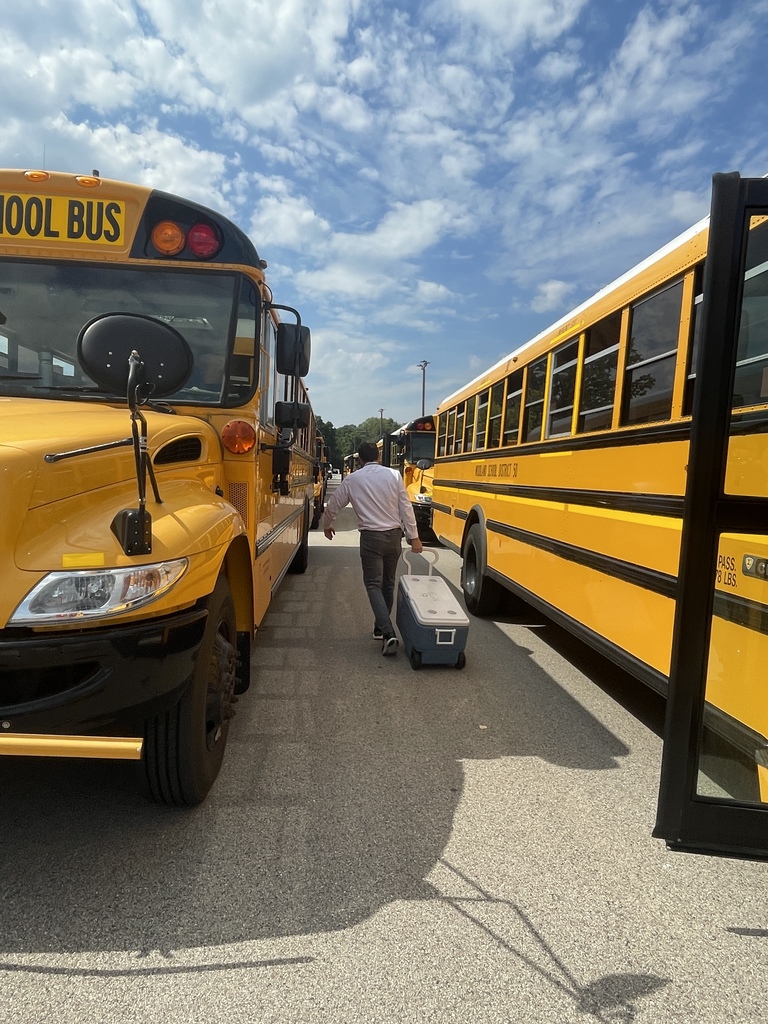 Passing out cold water to bus drivers on a hot day